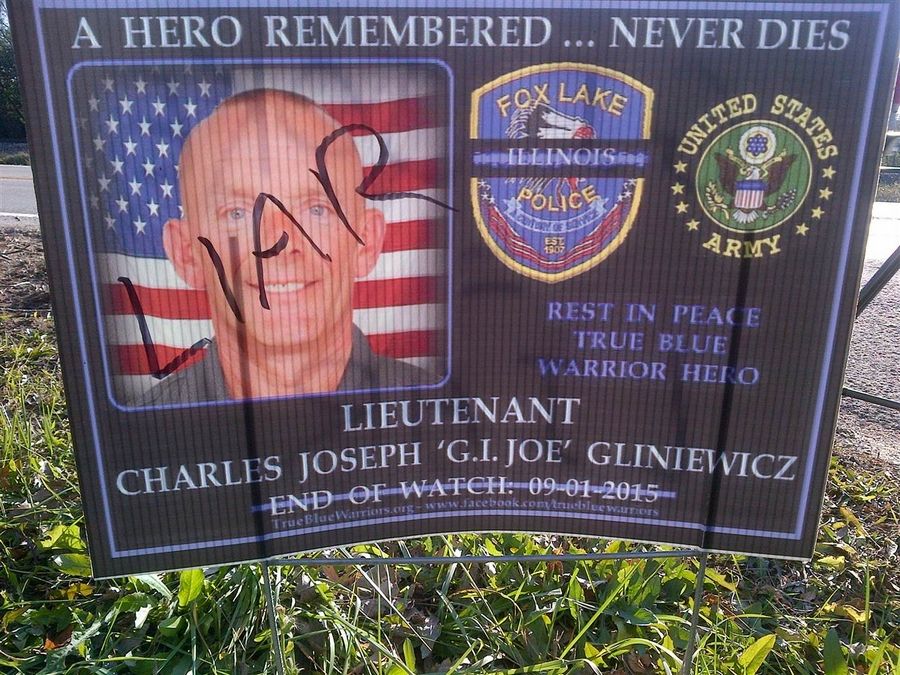 A sign once honoring Fox Lake police Lt. Gliniewicz is defaced after it is determined his death is a suicide.