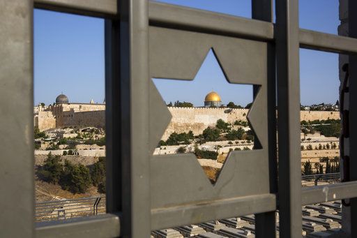 Jerusalem's Old City is seen trough a door with the shape of star of David, Tuesday, July 25, 2017. Israel has begun dismantling metal detectors it installed a week earlier at the gates of a contested Jerusalem shrine, amid widespread Muslim protests.