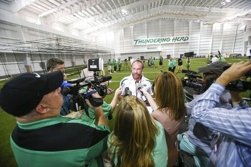 In this Sept. 6, 2014 photo, Chris Cline speaks with media as Marshall University dedicates the new indoor practice facility as the Chris Cline Athletic Complex in Huntington, W.Va. Police in the Bahamas say a helicopter flying from Big Grand Cay island to Fort Lauderdale has crashed, killing seven Americans on board.  None of the bodies recovered from the downed helicopter have been identified, but police Supt. Shanta Knowles told The Associated Press on Friday, July 5, 2019,  that the missing-aircraft report from Florida said billionaire Chris Cline was on board. (Sholten Singer/The Herald-Dispatch via AP)
