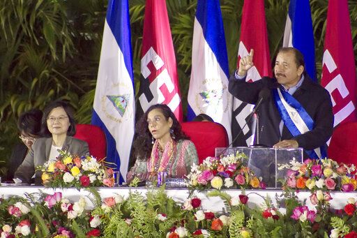 FILE - Nicaragua's President Daniel Ortega speaks during his inauguration ceremony, next to his wife Vice President Rosario Murillo, center, and Taiwan's President Tsai Ing-wen in Managua, Nicaragua, Tuesday, Jan. 10, 2017. Taiwan lost Nicaragua as a diplomatic ally, Thursday, Dec. 9, 2021, after the Central American country said it would officially recognize only China, which claims self-ruled Taiwan as part of its territory.