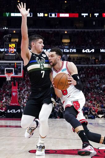 Chicago Bulls guard Zach LaVine, right, drives against Milwaukee Bucks guard Grayson Allen during the first half of Game 4 of a first-round NBA basketball playoff series, Sunday, April 24, 2022, in Chicago.
