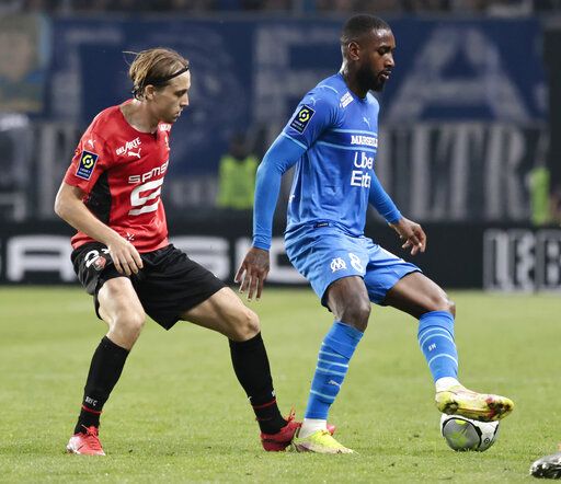 Marseille's Gerson, right, controls the ball under pressure from Rennes' Lovro Majer during a French League One soccer match between Rennes and Olympique Marseille at the Roazhon Park stadium in Rennes, France, Saturday, May 14, 2022.