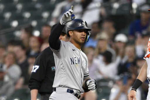 New York Yankees' Gleyber Torres gestures at first after he singled during the fourth inning of a baseball game against the Baltimore Orioles, Monday, May 16, 2022, in Baltimore.