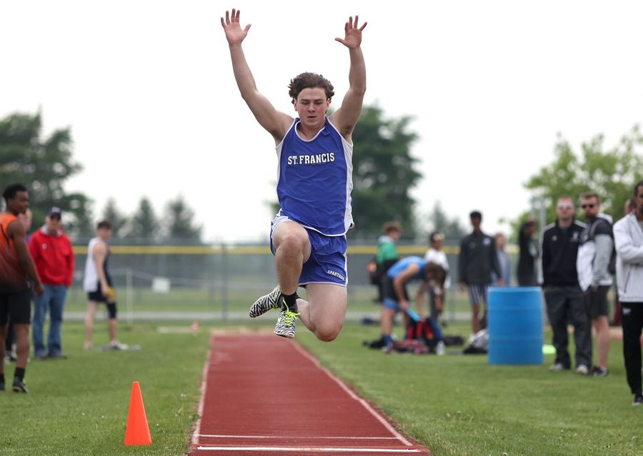 Sean Killian, from Wheaton St. Francis, competes in the long jump Wednesday, May 18, 2022, at the Class 2A boys track sectional at Rochelle High School.