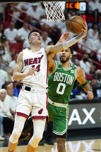 Miami Heat guard Tyler Herro (14) drives to the basket as Boston Celtics forward Jayson Tatum (0) defends during the first half of Game 2 of the NBA basketball Eastern Conference finals playoff series, Thursday, May 19, 2022, in Miami.