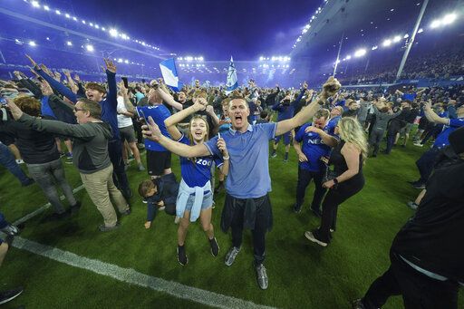 Everton fans celebrate the victory against Christal Palace during the English Premier League soccer match between Everton and Crystal Palace at Goodison Park in Liverpool, England, Thursday, May 19, 2022.