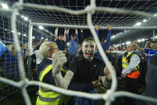 Everton fans celebrate the victory against Christal Palace during the English Premier League soccer match between Everton and Crystal Palace at Goodison Park in Liverpool, England, Thursday, May 19, 2022.