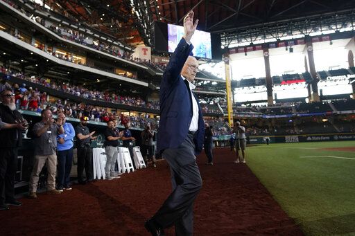 FILE - Baseball great and former Texas Rangers pitcher Nolan Ryan waves to the crowd as he takes the field for a screening of a documentary film about him, after a baseball ball game between the Atlanta Braves and Texas Rangers in Arlington, Texas, Sunday, May 1, 2022.
