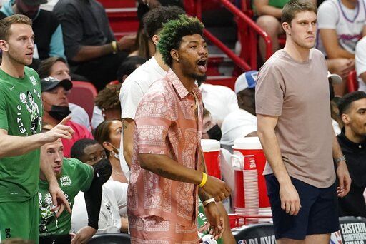 Boston Celtics guard Marcus Smart encourages his teammates from the sidelines during the first half of Game 1 of an NBA basketball Eastern Conference finals playoff series against the Miami Heat, Tuesday, May 17, 2022, in Miami.