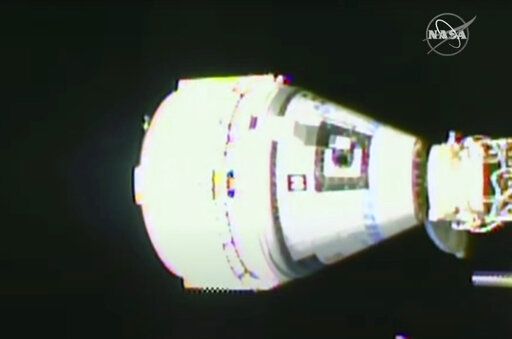 This image from NASA TV shows the Boeing Starliner docking at the International Space Station, Friday, May 20, 2022. Boeing's astronaut capsule has arrived at the International Space Station in a critical repeat test flight. Only a test dummy was aboard the capsule for Friday's docking, a huge achievement for Boeing after years of false starts. (NASA via AP)