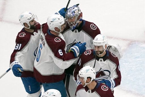 Colorado Avalanche goaltender Darcy Kuemper celebrates with teammates Nazem Kadri (91), Erik Johnson (6) and Andrew Cogliano (11) following a 5-2 victory over the St. Louis Blues in Game 3 of an NHL hockey Stanley Cup second-round playoff series Saturday, May 21, 2022, in St. Louis.