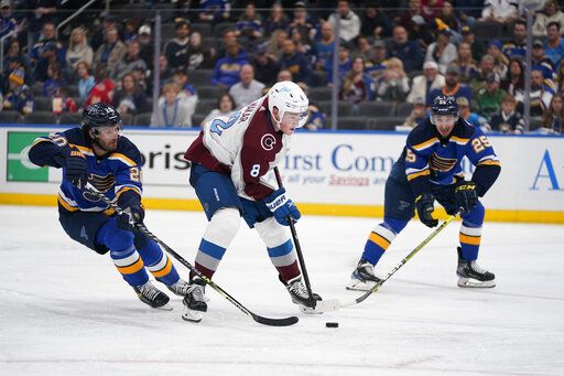 Colorado Avalanche's Cale Makar (8) handles the puck as St. Louis Blues' Brandon Saad (20) and Jordan Kyrou (25) defend during the third period in Game 3 of an NHL hockey Stanley Cup second-round playoff series Saturday, May 21, 2022, in St. Louis.