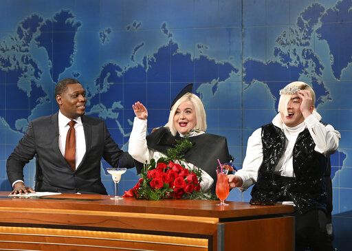 This image released by NBC shows Michael Che, left, with Aidy Bryant, center, and Bowen Yang during the "Weekend Update" segment on "Saturday Night Live" in New York on May 21, 2022. (Will Heath/NBC via AP)