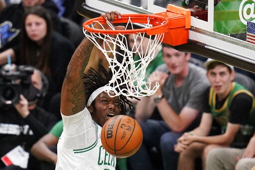 Boston Celtics center Robert Williams III (44) slams a dunk against the Miami Heat during the first half of Game 4 of the NBA basketball playoffs Eastern Conference finals, Monday, May 23, 2022, in Boston.