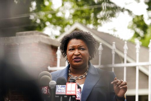 Georgia Democratic gubernatorial candidate Stacey Abrams talks to the media during Georgia's primary election on Tuesday, May 24, 2022, in Atlanta.