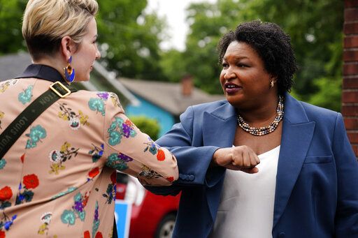 Georgia Democratic gubernatorial candidate Stacey Abrams greets a supporter during Georgia's primary election on Tuesday, May 24, 2022, in Atlanta.
