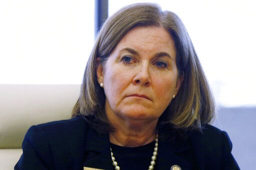FILE - Kansas City Federal Reserve President Esther George listens during a closed door meeting with representatives of the marijuana industry in Colorado, on April 9, 2015, in Denver. George, said Wednesday, ay 25, 2022, that she will retire in January, as required by the Fed's mandatory retirement rules.