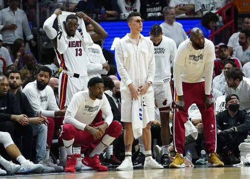 The Miami Heat bench follows the game as they fall behind the Boston Celtics during the second half of Game 5 of the NBA basketball Eastern Conference finals playoff series, Wednesday, May 25, 2022, in Miami.