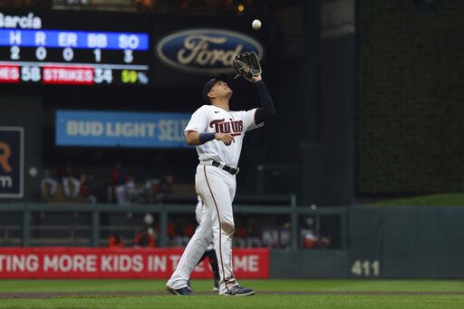 Minnesota Twins third baseman Gio Urshela catches a fly ball hit by Detroit Tigers' Jonathan Schoop during the fourth inning of a baseball game Wednesday, May 25, 2022, in Minneapolis.