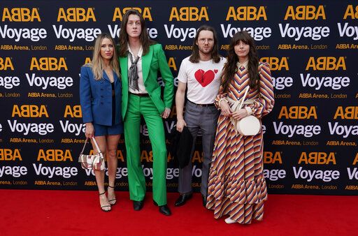 Members of the band Blossoms, centre right and center left, arrive for the ABBA Voyage concert at the ABBA Arena in London, Thursday May 26, 2022. ABBA is releasing its first new music in four decades, along with a concert performance that will see the "Dancing Queen" quartet going entirely digital. The virtual version of the band will begin a series of concerts on Thursday.