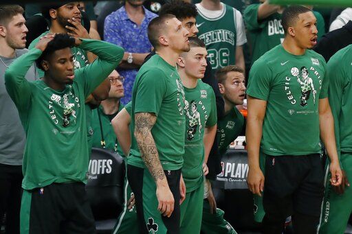 The Boston Celtics bench watches play during the second half of Game 6 of the team's NBA basketball playoffs Eastern Conference finals against the Miami Heat, Friday, May 27, 2022, in Boston.