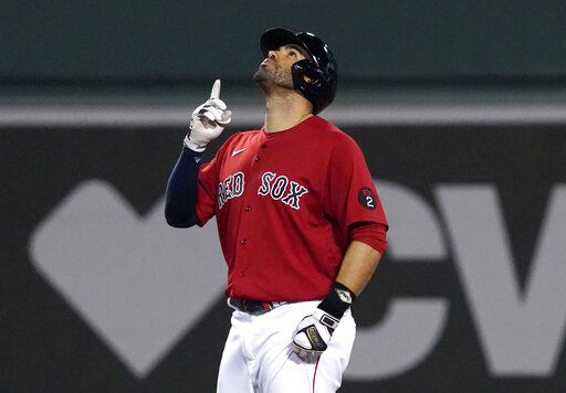 Boston Red Sox's J.D. Martinez gestures after hitting an RBI double against the Baltimore Orioles during the fourth inning of a baseball game at Fenway Park, Friday, May 27, 2022, in Boston.
