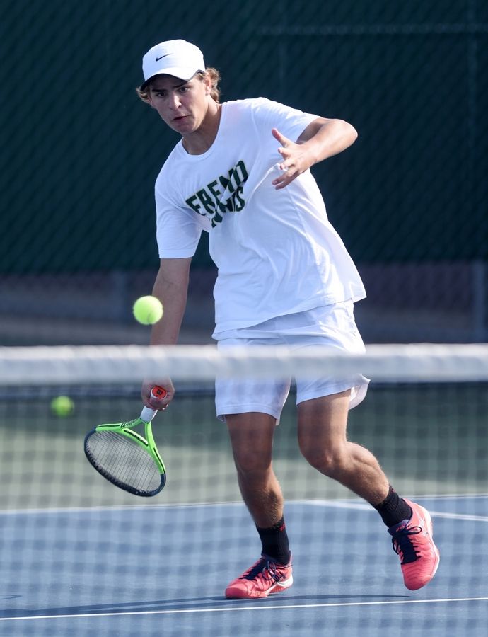 Fremd's Andrew Spurck drives a return in his semifinal match at the state tennis tournament in Arlington Heights.