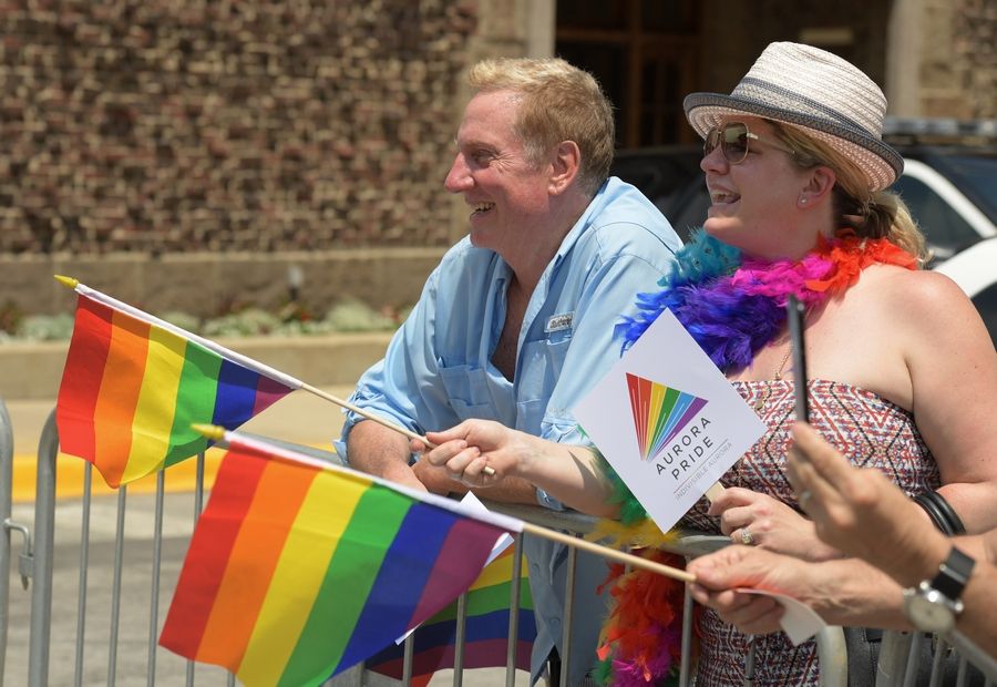 Dale Sporrer and Diana Law of Geneva enjoy the inaugural Aurora Pride Parade in 2018. The city temporarily revoked the permit for this year's parade until it found enough police officers to work the event.