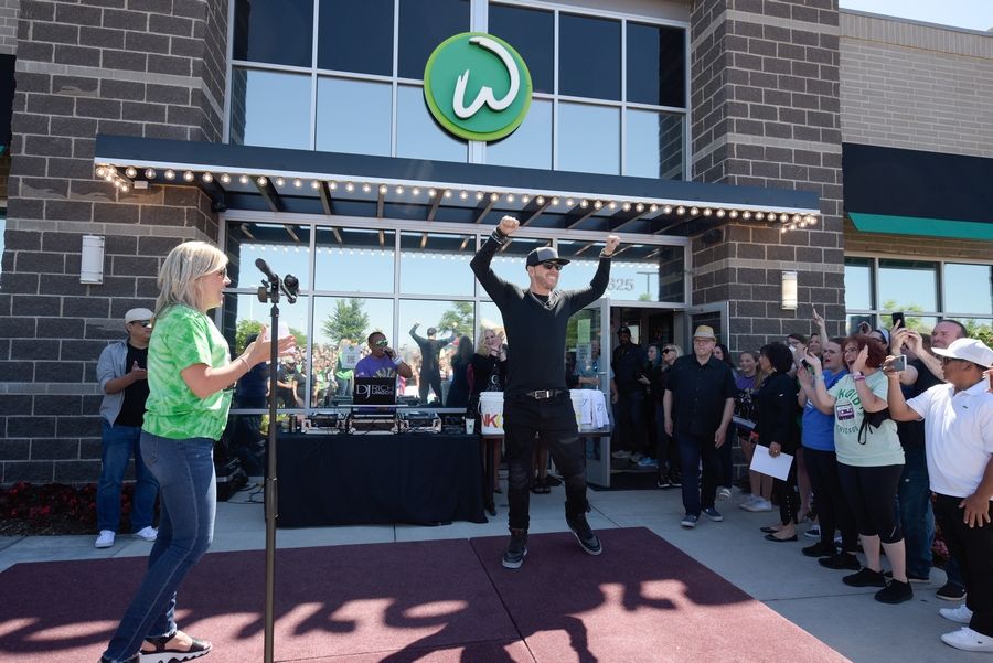St. Charles Mayor Lora Vitek introduces Donnie Wahlberg and the rest of the New Kids on the Block band during the Wahlk of Fame Ceremony Saturday at the Wahlburgers in St. Charles.
