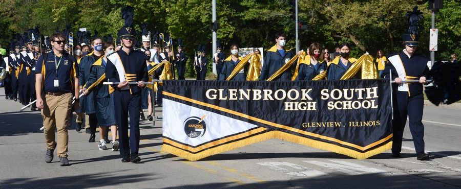 Members of the Glenbrook South High School marching band carry their banner during the school's homecoming parade.