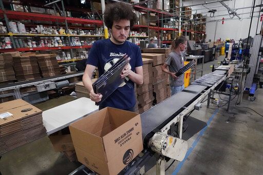 Elijah Lindsay loads finished vinyl records into shipping boxes at the United Record Pressing facility Thursday, June 23, 2022, in Nashville, Tenn. Vinyl record manufacturers are rapidly rebuilding an industry to keep pace with sales that topped $1 billion last year.