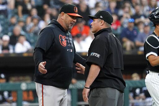 Baltimore Orioles manager Brandon Hyde, left, talks with umpire Marvin Hudson after the benches cleared when an Orioles batter was hit by a pitch during the second inning of the team's baseball game against the Chicago White Sox in Chicago, Friday, June 24, 2022.