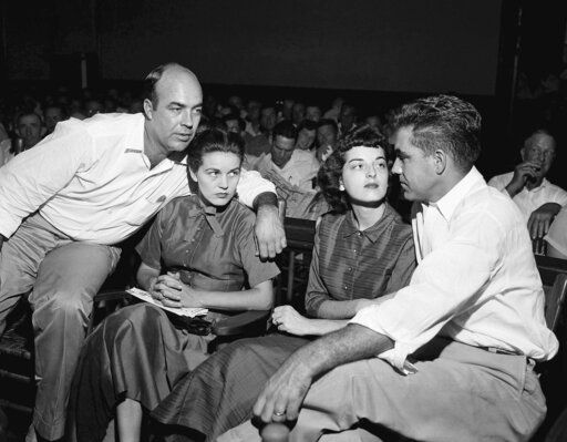 FILE - In this Sept. 23, 1955, file photo, J.W. Milam, left, his wife, second from left, Roy Bryant, far right, and his wife, Carolyn Bryant, sit together in a courtroom in Sumner, Miss. Bryant and his half-brother Milam were charged with murder but acquitted in the kidnapping and torture slaying of 14-year-old black teen Emmett Till in 1955 after he allegedly whistled at Carolyn Bryant. A team searching the basement of a Mississippi courthouse for evidence about the lynching of Black teenager Emmett Till has found the unserved warrant in June 2022 charging a white woman in his kidnapping in 1955, and relatives of the victim want authorities to finally arrest her nearly 70 years later.