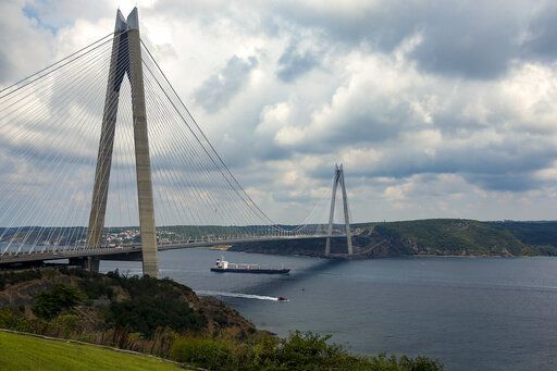 The Sierra Leone-flagged cargo ship Razoni sails under Yavuz Sultan Selim Bridge after being inspected by Russian, Ukrainian, Turkish and U.N. officials at the entrance of the Bosphorus Strait in Istanbul, Turkey, Wednesday, Aug. 3, 2022. The cargo ship Razoni, loaded up with 26,000 tons of corn, is the first cargo ship to leave Ukraine since the Russian invasion, and set sail from Odesa on Monday, August 1, 2022. Its final destination is Lebanon.