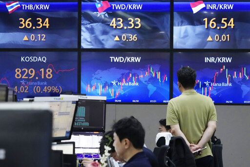 A currency trader watches screens showing the foreign exchange rates at the foreign exchange dealing room of the KEB Hana Bank headquarters in Seoul, South Korea, Friday, Aug. 5, 2022. Asian stock markets rose Friday ahead of U.S. job market data that might influence Federal Reserve decisions about further interest rate hikes.