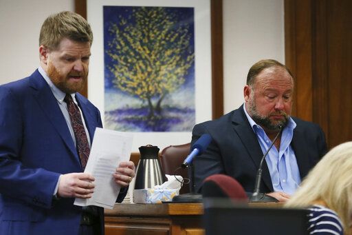 Mark Bankston, lawyer for Neil Heslin and Scarlett Lewis, asks Alex Jones questions about text messages during trial at the Travis County Courthouse in Austin, Wednesday Aug. 3, 2022. Jones testified Wednesday that he now understands it was irresponsible of him to declare the Sandy Hook Elementary School massacre a hoax and that he now believes it was 'œ100% real." (Briana Sanchez/Austin American-Statesman via AP, Pool)