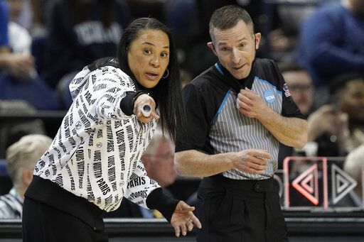 FILE - South Carolina head coach Dawn Staley speaks with an official during the first half of a college basketball game against Creighton in the Elite 8 round of the NCAA tournament in Greensboro, N.C., Sunday, March 27, 2022. Staley said referees on the men's side should be 'œstepping up'� and advocating for equal pay for women's referees. 'œThey don't do anything different," she said. 'œWhy should our officials get paid less for taking the (expletive) we give them?"