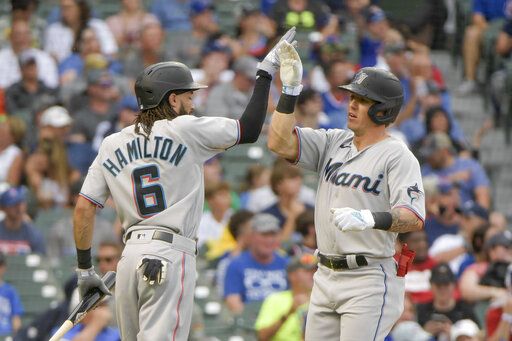 Miami Marlins' Billy Hamilton (6) congratulates Peyton Burdick, right, on Burdick's fifth-inning home run against the Chicago Cubs during a baseball game, Sunday, Aug. 7, 2022, at Wrigley Field in Chicago.