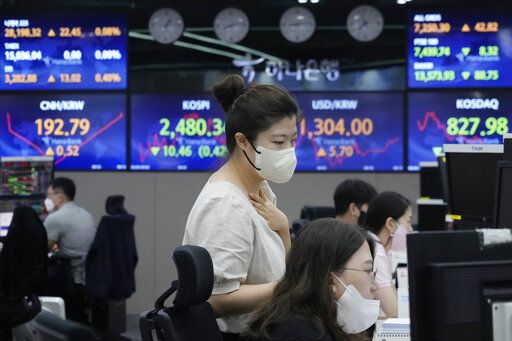 Currency traders watch monitors at the foreign exchange dealing room of the KEB Hana Bank headquarters in Seoul, South Korea, Monday, Aug. 8, 2022. Asian stocks were mixed Monday after strong U.S. jobs data cleared the way for more interest rate hikes and Chinese exports rose by double digits.