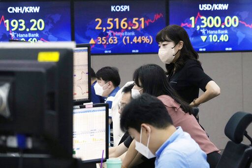 Currency traders watch monitors at the foreign exchange dealing room of the KEB Hana Bank headquarters in Seoul, South Korea, Thursday, Aug. 11, 2022. Shares advanced Thursday in Asia after benchmarks closed at three-month highs on Wall Street as investors cheered a report showing inflation cooled more than expected in July.