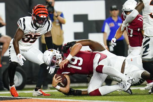 Arizona Cardinals quarterback Trace McSorley (19) is tackled by Cincinnati Bengals cornerback Cam Taylor-Britt (29) in the second quarter an NFL football preseason game in Cincinnati, Friday, Aug. 12, 2022.