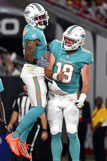 Miami Dolphins wide receiver Lynn Bowden Jr. (3) celebrates with quarterback Skylar Thompson (19) after scoring against the Tampa Bay Buccaneers during the first half of an NFL preseason football game Saturday, Aug. 13, 2022, in Tampa, Fla.