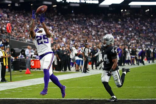 Minnesota Vikings wide receiver Albert Wilson catches a touchdown pass ahead of Las Vegas Raiders cornerback Bryce Cosby during the second half of an NFL preseason football game, Sunday, Aug. 14, 2022, in Las Vegas.
