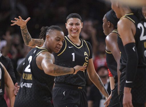 Las Vegas Aces guard Kierstan Bell (1) celebrates with teammates during the second half of a WNBA basketball game against the Seattle Storm, Sunday, Aug. 14, 2022, in Las Vegas.