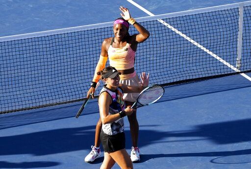 Coco Gauff, top, and Jessica Pegula, both of the United States, react after defeating Nicole Melichar-Martinez, also of the United States and Ellen Perez, of Australia, in the doubles final at the National Bank Open tennis tournament in Toronto, Sunday, Aug. 14, 2022. (Nathan Denette/The Canadian Press via AP)