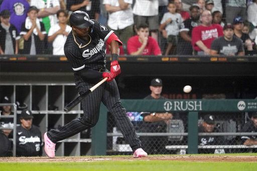 Chicago White Sox's Eloy Jimenez hits a two-run double during the eighth inning of the team's baseball game against the Houston Astros on Monday, Aug. 15, 2022, in Chicago. The White Sox won 4-2.