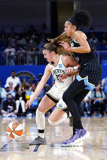 New York Liberty guard Sabrina Ionescu, left, drives against Chicago Sky forward Candace Parker during the first half in Game 1 of a WNBA basketball first-round playoff series Wednesday, Aug. 17, 2022, in Chicago.