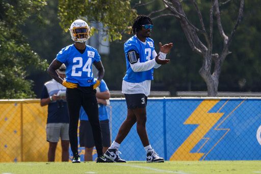 Los Angeles Chargers safeties Derwin James Jr. right, applauds next to Nasir Adderley (24) during the NFL football team's training camp Wednesday, July 27, 2022, in Costa Mesa, Calif.