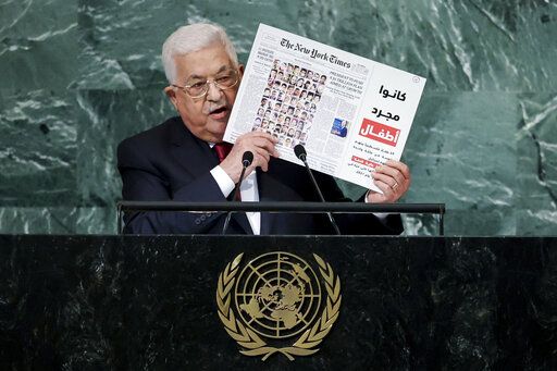 Palestinian President Mahmoud Abbas holds up a graphic showing the May 28, 2021 front page of The New York Times while addressing the 77th session of the United Nations General Assembly, Friday, Sept. 23, 2022, at the U.N. headquarters.