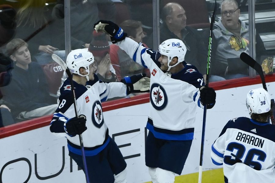 Winnipeg Jets right wing Saku Maenalanen (8) celebrates with center Dominic Toninato after Maenalanen scored a goal against the Chicago Blackhawks during the second period of an NHL hockey game, Sunday, Nov. 27, 2022, in Chicago.